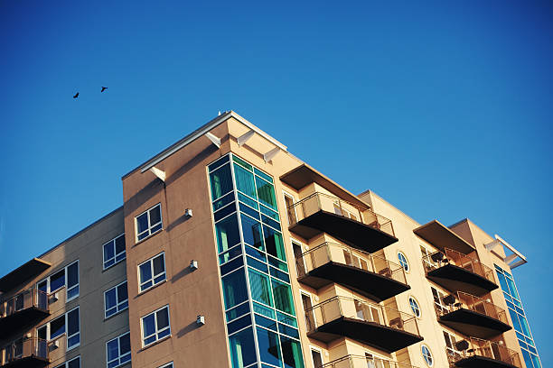 istock apartment building under sunny clear blue sky and two birds 147289655