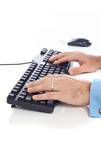 Hands on computer keyboard stock photo