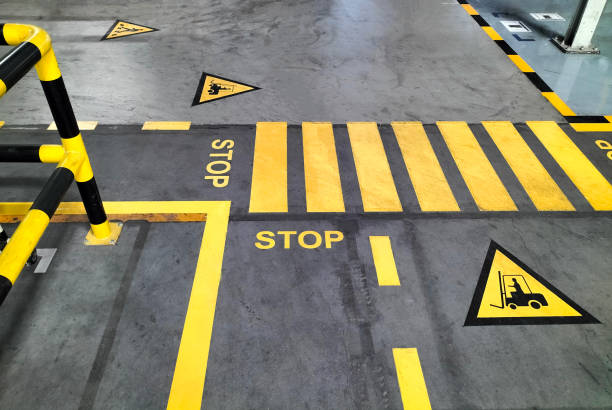 walk way Industrial building corridor painted yellow between parallel yellow lines on abstract cement background. Sidewalk Negotiation Safety Concept road marking stock pictures, royalty-free photos & images