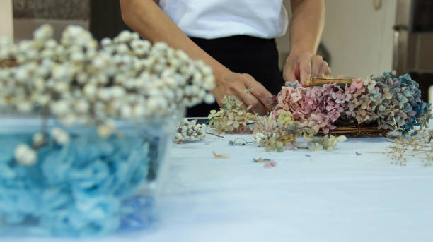 istock A female florist is making a wreath with hydrangeas 1472907666