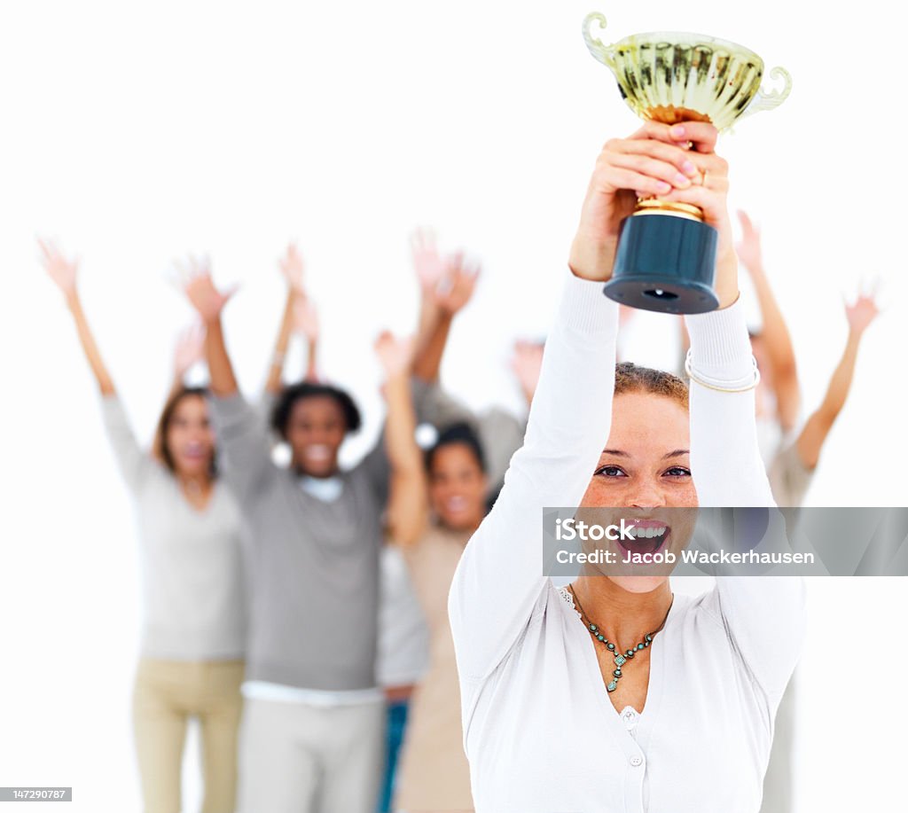 Excited young woman holding cup Trophy - Award Stock Photo