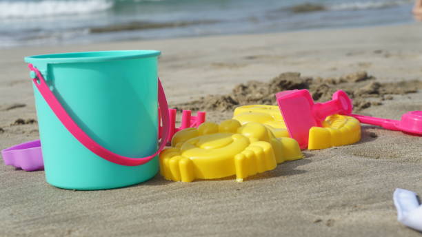 istock Beach kids toys on white sand beach 1472908769