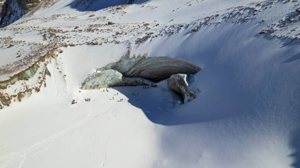 istock A huge glacier in the mountains and tourists 1472910657