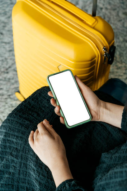 istock Using phone in travelling. Blank screen smartphone at the airport before the flight. Application for travel, banking, concept. 1472911226
