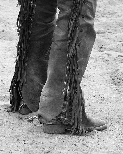 Boots, Chaps and Spurs in the Sand stock photo