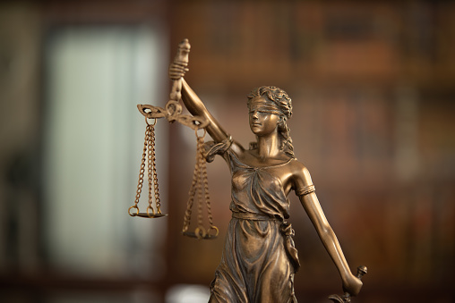 Justice law legal concept. statue of justice or lady justice with bokeh background.