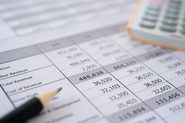 accounting business Accounting business concept. Calculator with accounting report and financial statement on desk. financial statement stock pictures, royalty-free photos & images