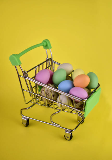 istock Easter eggs in a shopping basket on a yellow background. 1472918850