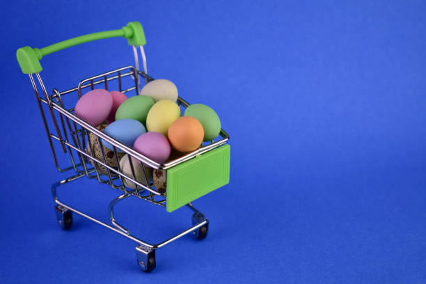 istock Easter eggs in a shopping basket on a blue background.Copy space. 1472919494