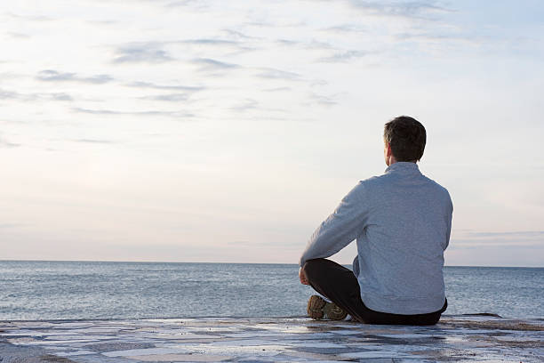 istock Man meditating at the sea 147292087