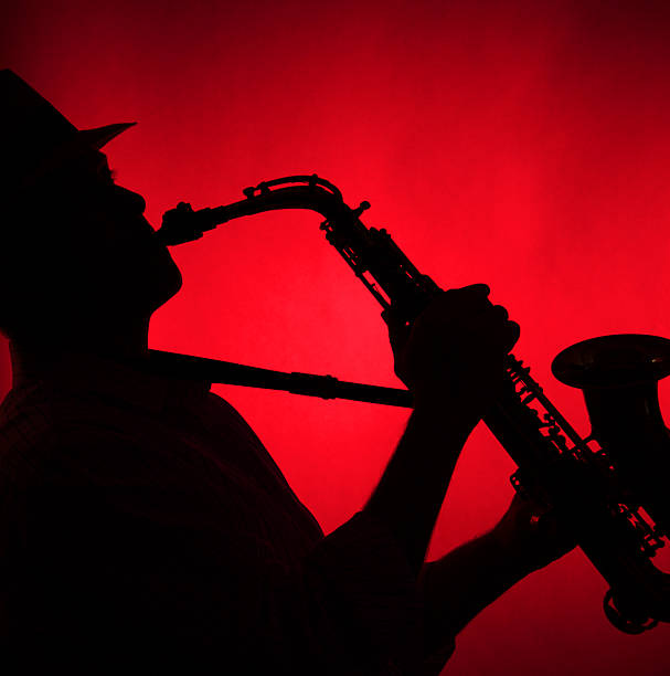 istock Saxophone Played in Silhouette Red Background 147292144