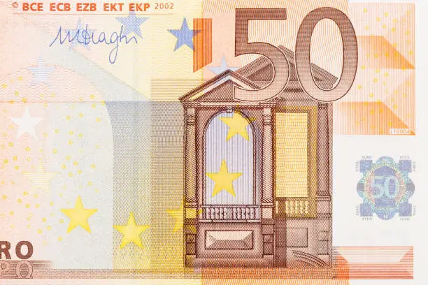 Part of Fifty Euro banknote. Euro currency in Europe. Financial colorful background. Concept of printing money from the European mint and the European Central Bank ECB