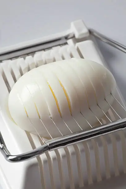 Hard boiled egg in an egg-slicer