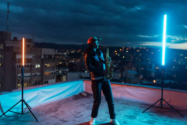 istock Woman enjoying rooftop saxophone session 1472924848