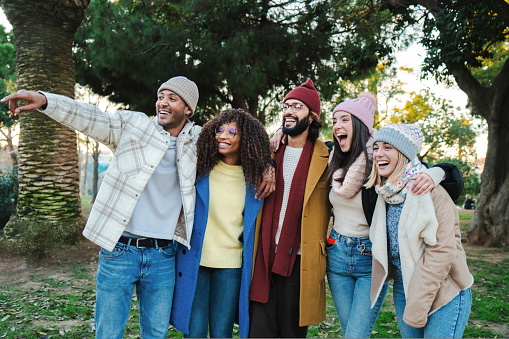 A group of young friends in a holiday or vacation trip having fun together. Multiracial happy people smiling enjoying a outumn weekend day. Lifestyle concept. High quality photo