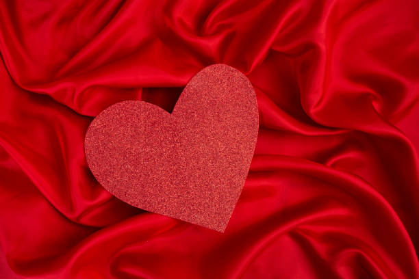 istock Red glitter heart with satin folds background 1472930691