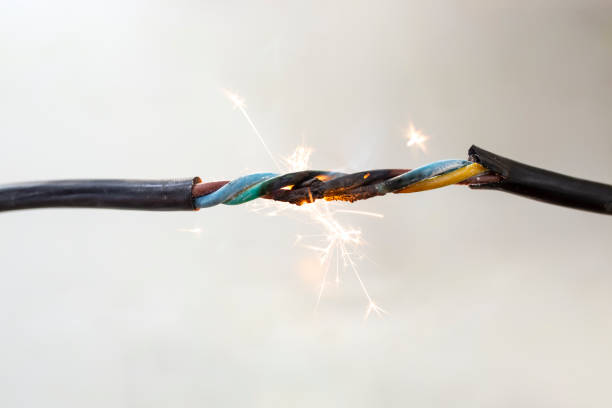 istock flame smoke and sparks on an electrical cable, fire hazard concept 1472930724