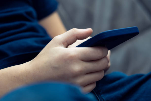 Thai woman's hand using mobile phone
