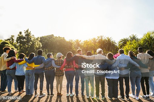 istock Group of multigenerational people hugging each others - Support, multiracial and diversity concept - Main focus on senior man with white hairs 1472932742