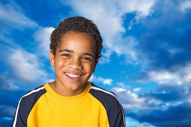 Boy, blue sky and clouds stock photo