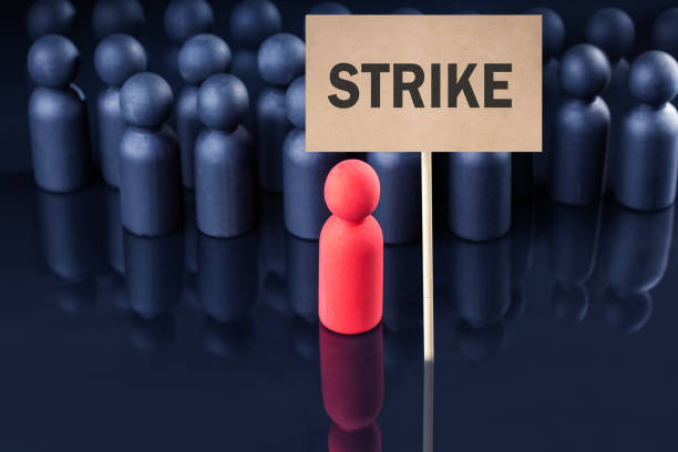 istock Strike of workers.  group of protesting people with placard. 1472936538