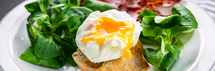 egg poached fesh breakfast bacon, green leaves salad healthy meal food snack on the table copy space