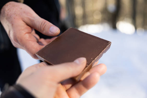 istock caucasian persons exchanging a piece of chocolate 1472938658