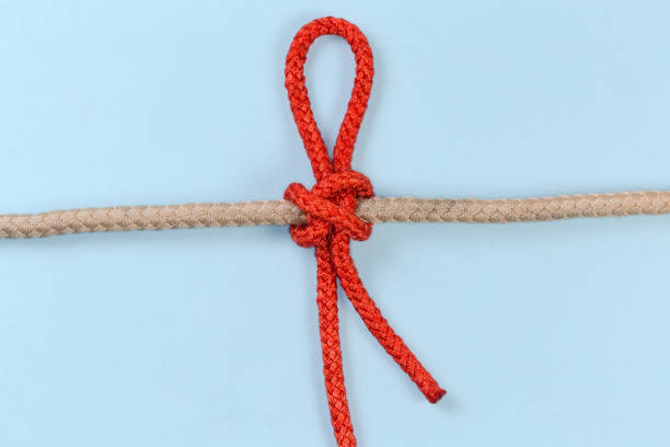 istock Tightened rope Slipped constrictor knot on a blue background 1472939458