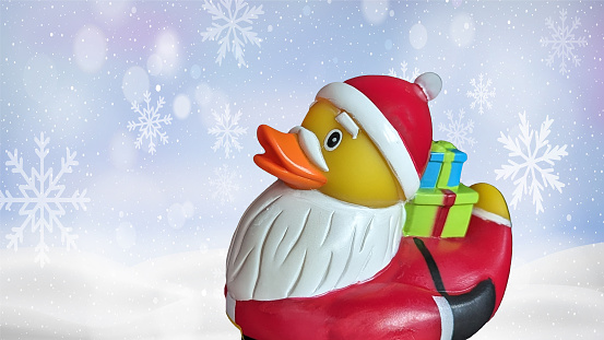 Santa rubber duck on snowy background