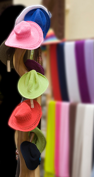 Multicolored hats and scarves for women, retail display  in the street. Galicia, Spain.