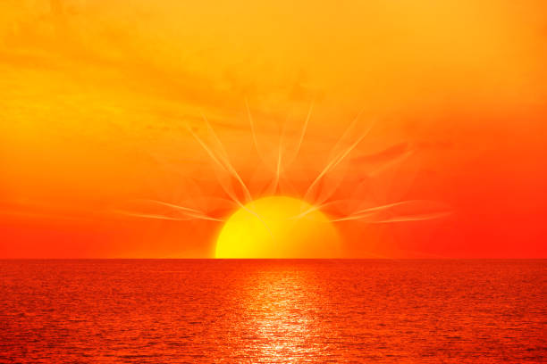 istock Sunrise with sun rays over sea 1472940912