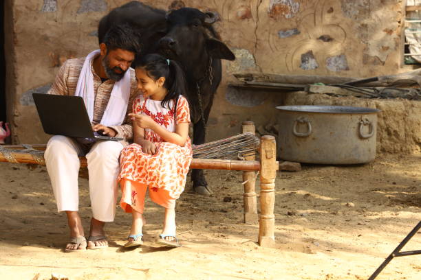istock father teaching daughter how to use a laptop. 1472941002