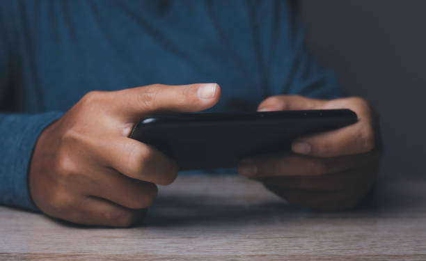 istock Man watching video on his mobile phone. 1472942017