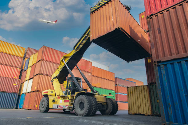 istock Airplane flying above commercial port. 1472942174