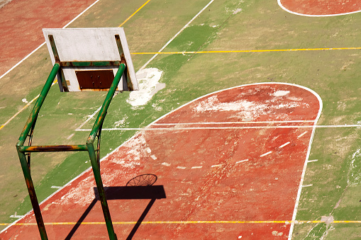 Empty old basketball court in the sunlight.