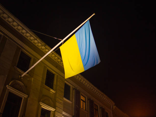 istock Ukrainian Flag hanging on a flagpole from a building. 1472944340