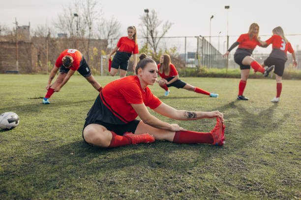 istock Female rugby players stretching 1472944700