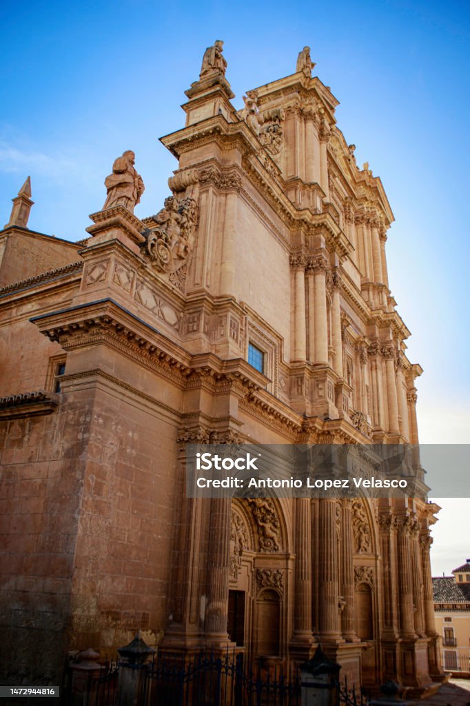 Side view of the monumental façade of the Collegiate Church of San Patricio in Renaissance style Side view of the monumental façade of the Collegiate Church of San Patricio in Renaissance style and profusely decorated with sculptures in Lorca, Murcia, Spain Architecture Stock Photo