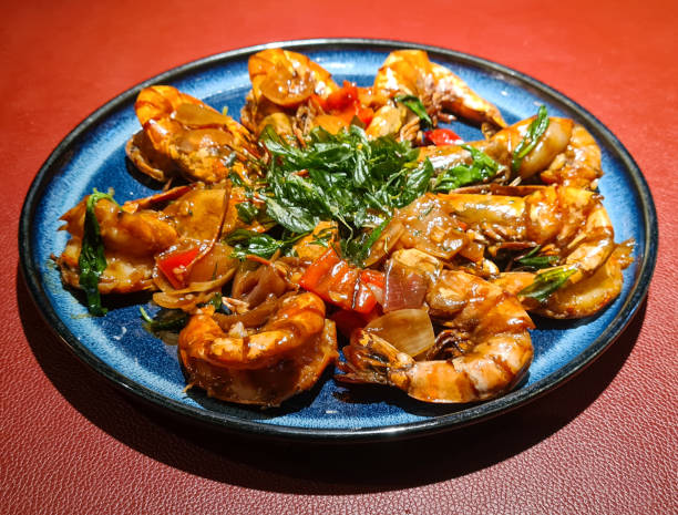 Pan Fried Tiger Prawn with Basil: Lavish Chinese Cuisine served on a Red Leather Table