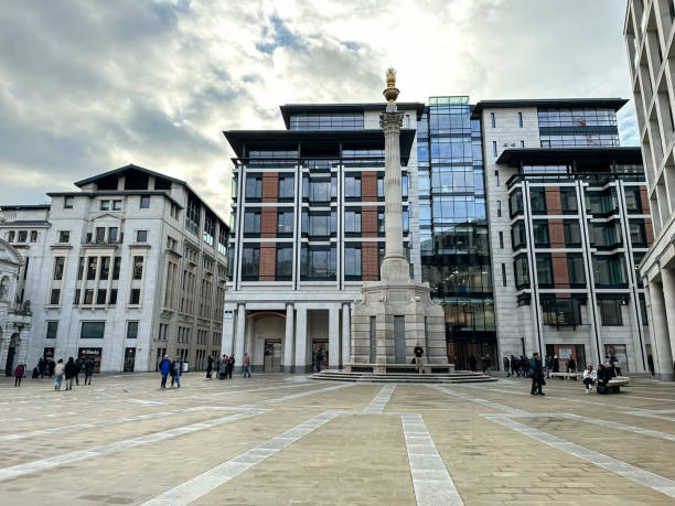 Paternoster Square in London Paternoster Square in London, with London Stock Exchange building on the left, Patersnoster Square Column and commercial building behind the column, with statues and people. paternoster square stock pictures, royalty-free photos & images