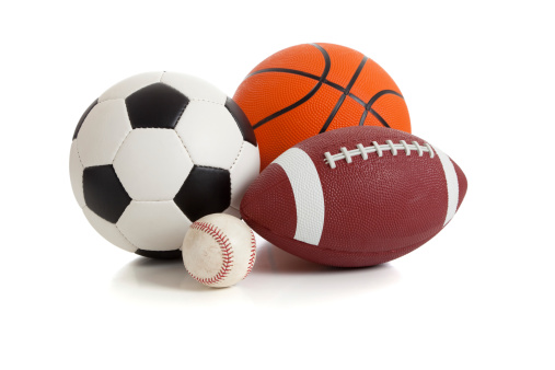 A group of sports balls on a white background including a baseball, basketball, a soccer ball and a football
