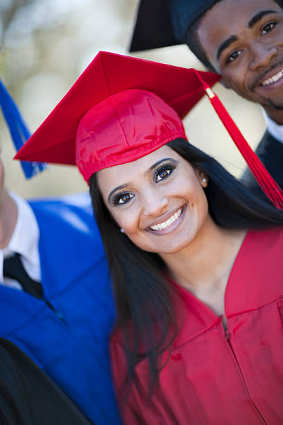 istock Ethnic Female Graduate With Two Classmates 147294845