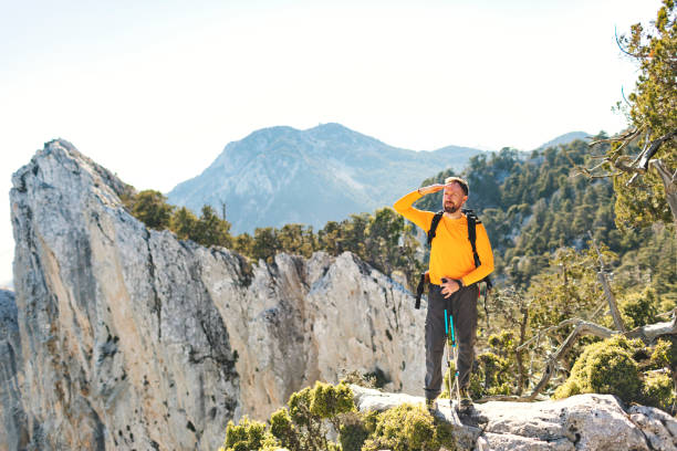 istock Adult man resting while mountain hike and looking at view 1472950268