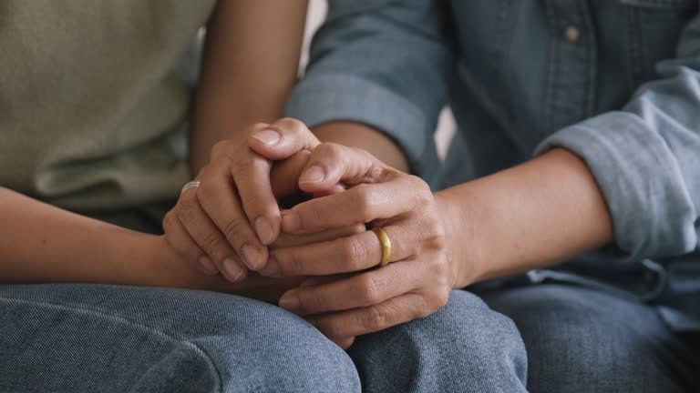 Mom looking at unhappy child consoling compassion with cheerful love.