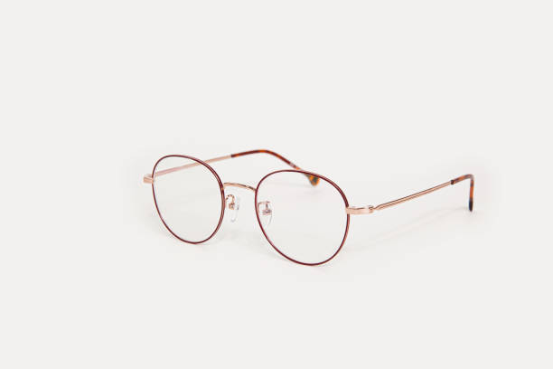 Stylish gold eyeglasses isolated on white background perspective view