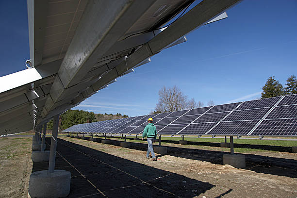 Solar panels inspected by workman stock photo