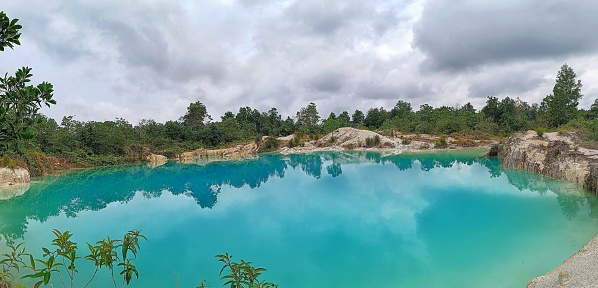 Beautiful blue lake views and calm water surface, lined tropical forests, under the former tin mining Bangka Island - Indonesia