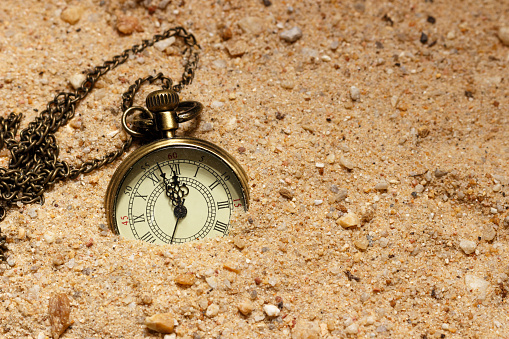 Retro style clock in the sand