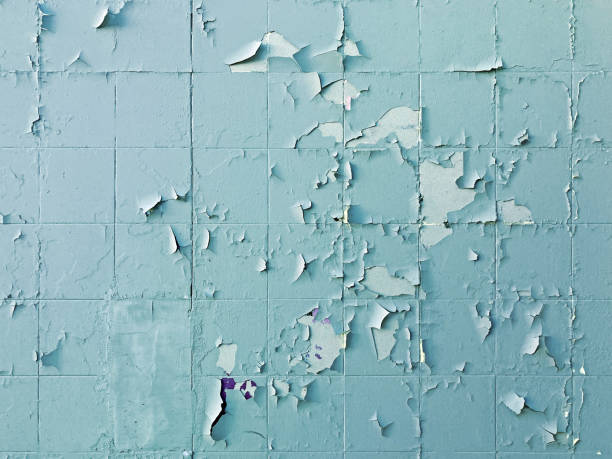 istock Texture, pattern, background. old paint. Concrete wall cracked paint, paint abstractly behind the concrete. With white tone paint flakes off over time 1472954514
