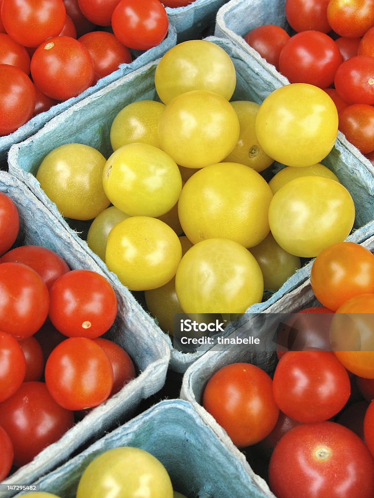 Cherry tomatoes for sale at a farmers' market Red and yellow cherry tomatoes for sale at a farmers' market Agriculture Stock Photo